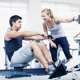 A trainer encourages her client during a workout. Deer Antler Velvet helps improve your endurance and energy levels in gym.